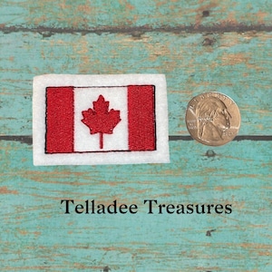 May include: A red and white Canadian flag patch with a red maple leaf in the center. The patch is about the size of a US quarter.
