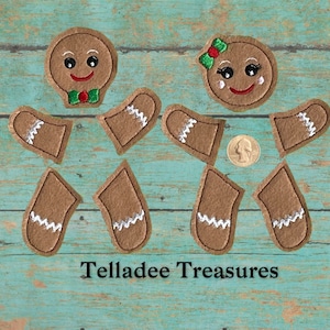 May include: A set of felt gingerbread people craft pieces. The set includes two heads, four arms, and four legs. The gingerbread people are brown with white icing details. The heads have smiling faces with black eyes and red mouths. One head has a green bow tie and the other has a red bow.