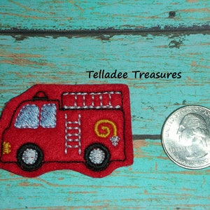 May include: Red felt fire truck applique with black stitching, yellow wheels, and a white ladder. The applique is about the size of a US quarter.