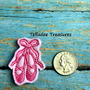 May include: Pink felt ballerina shoe applique with a bow. The applique is about the size of a US quarter.