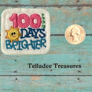 May include: A white felt patch with colorful embroidery that reads "100 Days Brighter". A smiling sun with yellow rays is above the text. The patch is next to a US quarter.