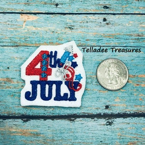 May include: A white felt patch with red, white, and blue embroidery depicting the number "4" with the word "July" below it. The number "4" has a firework design and stars. The patch is about the size of a US quarter.