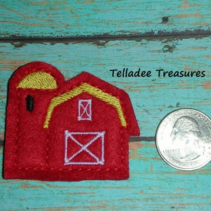 May include: Red felt barn applique with a yellow roof and white accents. The barn is approximately the size of a US quarter.