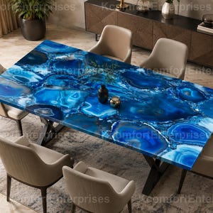 May include: A rectangular dining table featuring a polished blue agate gemstone tabletop with intricate white and dark blue veining, supported by a black metal X-shaped base, accompanied by six beige upholstered chairs with curved backrests.