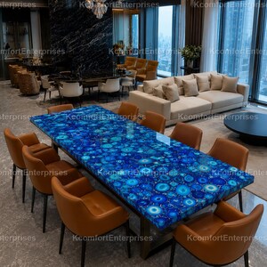 May include: A large rectangular dining table with a vibrant blue patterned surface, surrounded by ten brown leather chairs. The table is the focal point of a modern dining room.