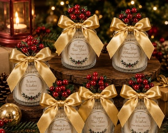 May include: Six glass candle jars with ribbed textures, each adorned with a gold satin ribbon bow and a cluster of red holly berries. Each jar features a circular label with holiday text, family names, and the year 2026, decorated with holly.