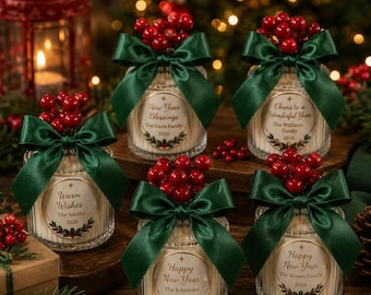 May include: Five glass candle jars with ribbed textures, each featuring a dark green satin ribbon bow and a cluster of red berries on top. Each jar has a circular label with holiday text, family names, and the year 2026 printed in black ink.