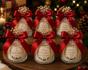 May include: Six clear ribbed glass jars filled with matchsticks, each topped with a deep red satin ribbon bow and dried baby's breath flowers. Each jar features a circular label with holiday text and family names, plus a Thank You gift tag.