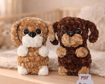 May include: Two plush dog toys, one light brown and one dark brown, with large black eyes and floppy ears. The dogs have white paws and muzzles. The text "PDF Pattern" is visible in the lower right corner.