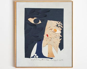 May include: Abstract paper collage artwork in a gold frame. The artwork features a face composed of dark blue, beige, and white paper cutouts. The face has one visible eye, a red lip, and the artist's signature.