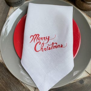 a white napkin with a merry christmas message on it
