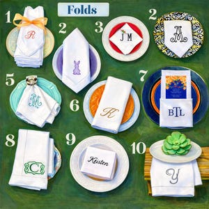 a collection of neatly folded napkins and place settings arranged on a green background.