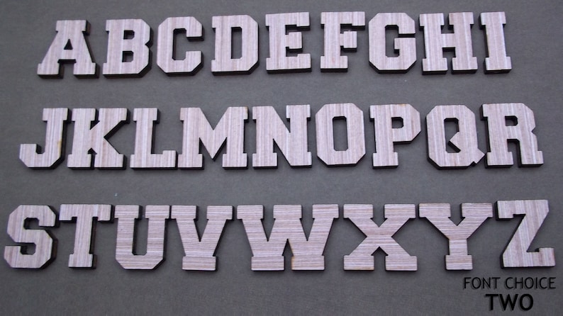 May include: A complete set of twenty-six uppercase English alphabet letters from A to Z, featuring a block-style varsity font with a light wood grain texture. The letters are arranged in three rows, with the text FONT CHOICE TWO in the bottom right.
