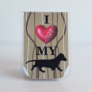 May include: A brown and white striped card with a red heart and the text "I love my" and a black silhouette of a dachshund.