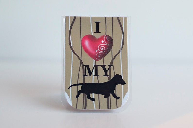 May include: A brown and white striped card with a red heart and the text "I love my" and a black silhouette of a dachshund.