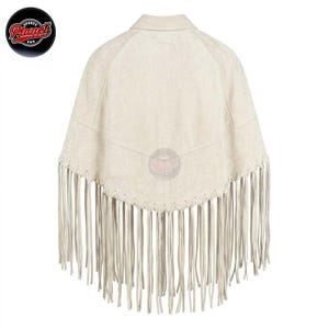Women's genuine suede leather fringe western boho cape poncho — A cream-colored suede jacket featuring a pointed back yoke, a classic collar, and long fringe trim along the bottom hem. The garment displays a textured surface and includes a circular S