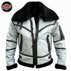 May include: A white and black shearling jacket with a black fur collar and trim. The jacket has a zipper closure, black leather accents, and two zippered pockets. The Sports Planet logo is visible in the upper left corner.