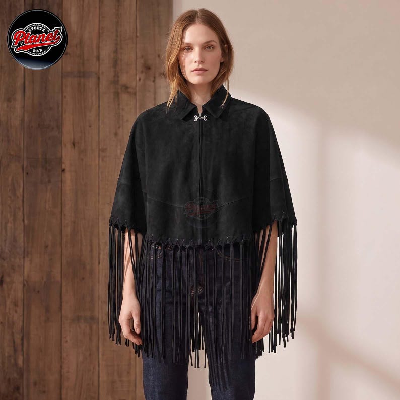 Women's genuine suede leather fringe western boho cape poncho — A black suede cape featuring a collared neckline, a silver-toned metal clasp closure at the neck, and long fringe detailing along the hemline. The garment has a structured shoulder desig