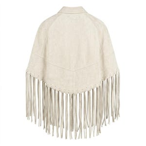 Women's genuine suede leather fringe western boho cape poncho — A beige suede poncho featuring a pointed hemline with long, thin fringe detailing along the bottom edge. The garment includes a structured collar and a V-shaped seam across the upper bac