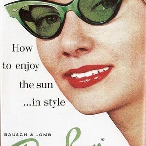 May include: Vintage advertisement featuring a woman wearing green Ray-Ban sunglasses. The sunglasses have a cat-eye shape. The ad includes the text "How to enjoy the sun...in style" and the Ray-Ban logo.