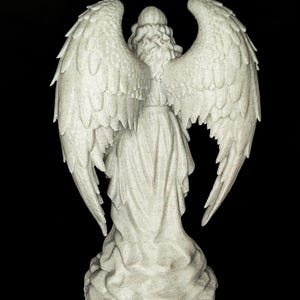 May include: A detailed, rear view of a white angel statue with large, textured wings. The angel is wearing a flowing gown and has curly hair. The statue is set against a black background.