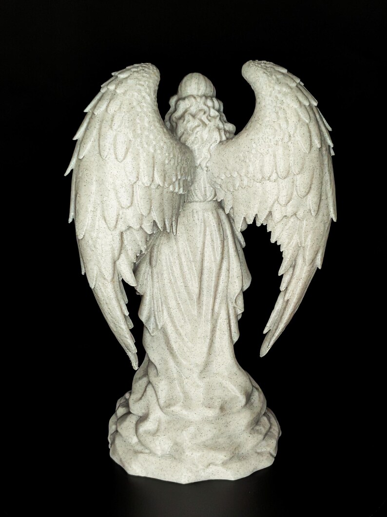 May include: A detailed, rear view of a white angel statue with large, textured wings. The angel is wearing a flowing gown and has curly hair. The statue is set against a black background.