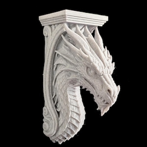 May include: A light gray, 3D-printed wall corbel featuring a detailed dragon head sculpture. The dragon has prominent scales, sharp horns, and a fierce expression. The corbel has a flat, rectangular top and a curved, ornate support structure.
