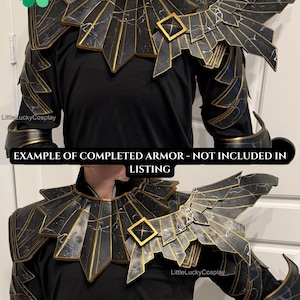 May include: Black and gold cosplay armor with a geometric design. The armor features a collar, shoulder pauldrons, and arm bracers. The armor has a black base with gold accents and a lightning bolt pattern. The text "EXAMPLE OF COMPLETED ARMOR - NOT INCLUDED IN LISTING" is visible.