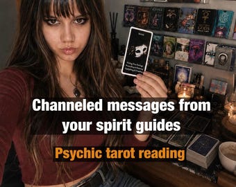 May include: A rectangular tarot card featuring a white mask graphic and the text MASK, Hiding True Feelings, Pretending & Frowning, Gaslighting & Projecting. The card is held up against a background of numerous tarot and oracle card decks.