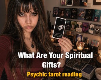 May include: A rectangular oracle card titled MASK featuring a white theatrical mask graphic and text. The card is held up against a background of numerous tarot and oracle decks arranged on shelves, with the text What Are Your Spiritual Gifts? Psychic tarot reading overlaid on the image.