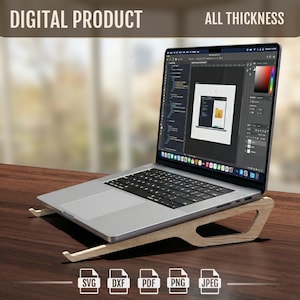 May include: A laptop computer rests on a wooden stand, angled for ergonomic use. The screen displays a design interface. The stand is light-colored wood, and the laptop is silver. The image includes the text "DIGITAL PRODUCT" and file type icons.