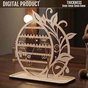 Pode incluir: Um organizador de joias de madeira com um design circular e detalhes de folhas. O organizador tem vários orifícios para brincos e ganchos para colares. O texto "DIGITAL PRODUCT" e "THICKNESS 3mm 4mm 5mm 6mm" são visíveis.