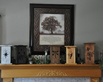 May include: A wooden mantelpiece displays framed artwork and decorative lanterns. The lanterns are painted in various colors and feature cut-out designs of a star, dragonfly, hummingbird, and mushroom. The artwork is a framed print of a tree.