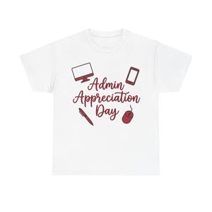 May include: A white short-sleeved t-shirt featuring a dark red graphic print that reads Admin Appreciation Day in a cursive script. The design includes illustrations of a computer monitor, a smartphone, a pen, and a computer mouse.