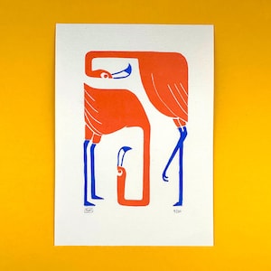 May include: A print featuring three stylized flamingos in orange and blue against a white background. The flamingos have long necks and legs, with the text "nan" and "9/50" visible.