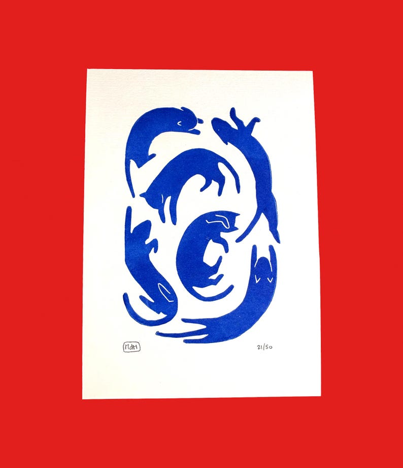 May include: A print featuring a collection of stylized blue cats in various poses on a white background. The artwork is set against a red backdrop. The print is numbered 21/50 and includes an artist's signature.
