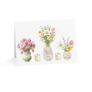 May include: A greeting card featuring three watercolor floral arrangements in vases and two lit candles. The vases display text: Grow in Grace 2 Peter 3:18, With God all things are possible Mark 10:27, and Rejoice in the Lord Philippians 4:4.