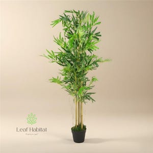 May include: An artificial bamboo plant with bright green leaves and light brown stalks. The plant is in a black pot. The logo "Leaf Habitat" is visible at the bottom left. The plant is approximately 150 cm tall.