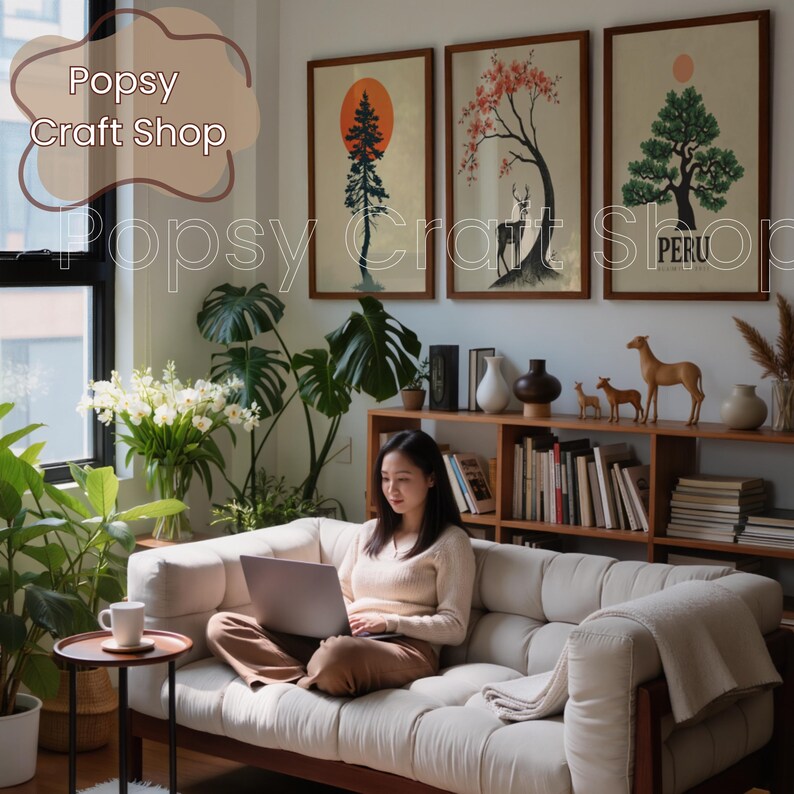 May include: A woman sits on a cream-colored sofa, using a laptop. Above, three framed art prints depict trees and a deer. The room is decorated with plants, books, and decorative items. The text "Popsy Craft Shop" is visible.