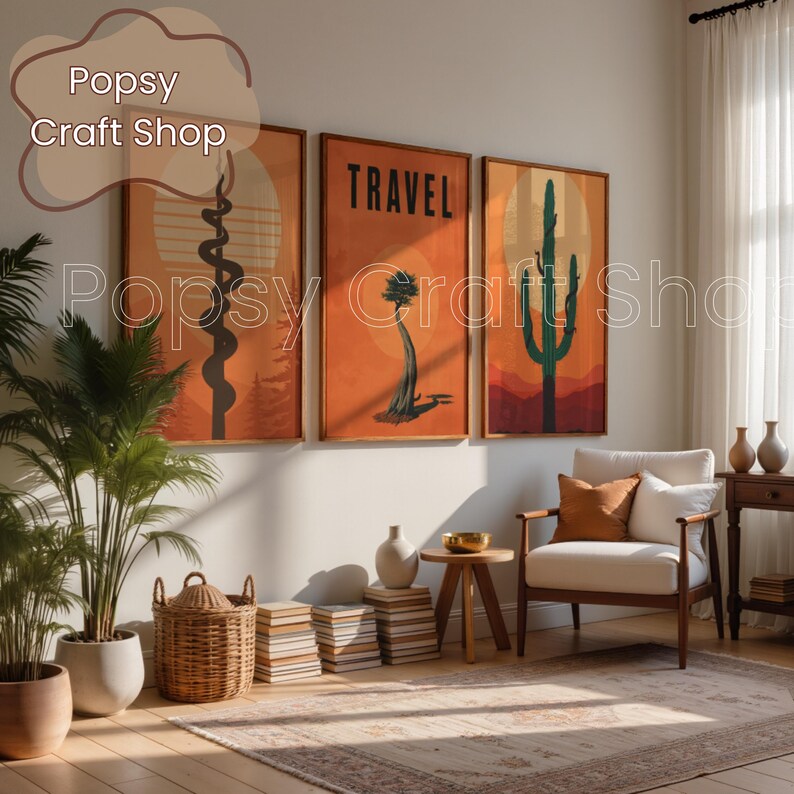 May include: Three framed art prints with desert landscape designs in orange, brown, and green hues. The middle print features the word "TRAVEL" in bold letters. The prints are displayed above a white armchair and a wooden side table, creating a warm, inviting atmosphere.