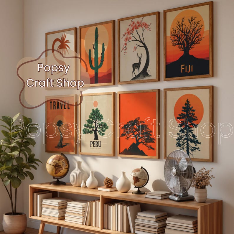 May include: A collection of framed art prints featuring nature-themed illustrations, including trees, cacti, and a deer, set against sunset-colored backgrounds. The prints are displayed above a wooden console with decorative items.