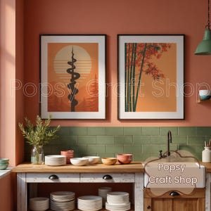 May include: Two framed art prints with a mid-century modern aesthetic. One features a stylized sun and mountain scene with a black, winding design. The other depicts bamboo stalks and red leaves against an orange background. The prints are displayed above a kitchen counter.