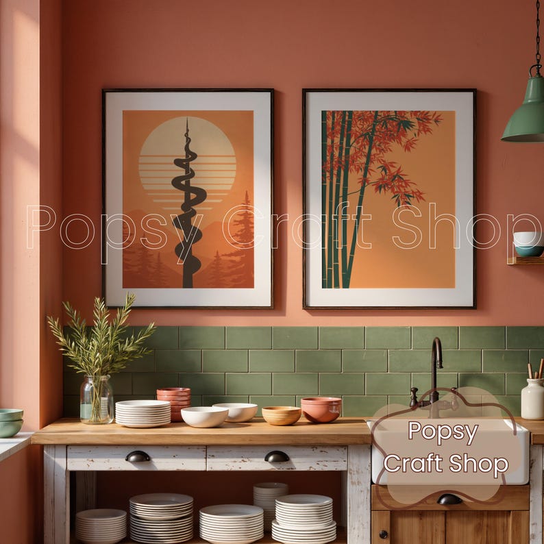 May include: Two framed art prints with a mid-century modern aesthetic. One features a stylized sun and mountain scene with a black, winding design. The other depicts bamboo stalks and red leaves against an orange background. The prints are displayed above a kitchen counter.