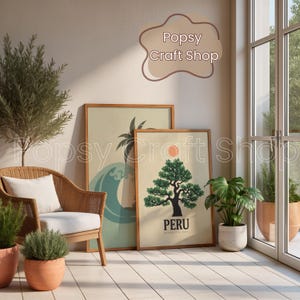 May include: Two framed art prints leaning against a wall. One features a wave and palm tree design, the other a tree with a sun and the word "PERU". A wicker chair with a white cushion and potted plants are in the foreground.