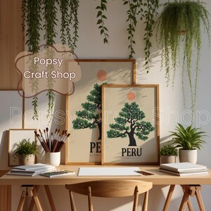 May include: A wooden desk with art supplies and framed prints featuring a tree design and the word "PERU". The prints have a beige background, a green tree, and a red sun. The text "Popsy Craft Shop" is visible.