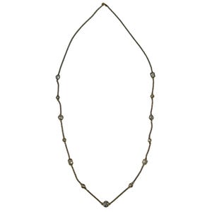 May include: A long gold-tone chain necklace featuring evenly spaced, circular and rectangular clear stone settings. The delicate metal chain connects each individual stone station, creating a symmetrical design that hangs in a simple, elongated oval shape.