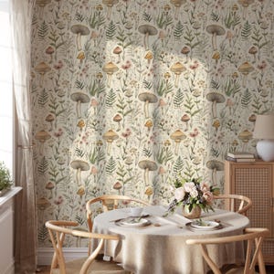 May include: A cream-colored wallpaper featuring a repeating pattern of mushrooms, ferns, and wildflowers in shades of brown, green, and pink. The design creates a whimsical, natural aesthetic, suitable for a variety of interior spaces.