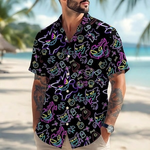 May include: Black button-down shirt with a neon-style pattern featuring cartoon ghosts, skulls, and crosses. The short-sleeved shirt has a classic collar and is made of a lightweight fabric, perfect for a casual look.