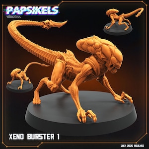 May include: An orange-colored Xeno Burster 1 figurine, posed on a black base. The figurine has a detailed, skeletal design with a long tail and a large head. The text "XENO BURSTER 1" is visible at the bottom of the image.