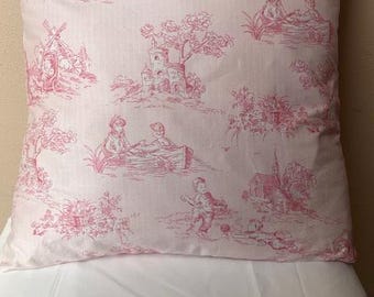 May include: A pink pillow with a white background and a repeating pattern of pink trees, houses, and people in boats. The pattern is a toile design.